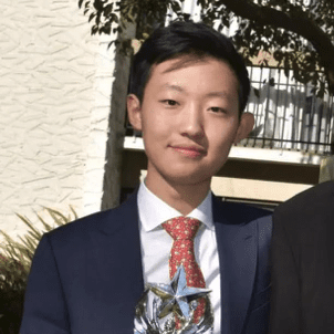 VDA debate student Andrew Liu holding Stanford Trophie
